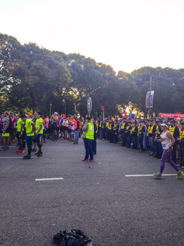 Me working corral H at the Chicago Marathon. I'm plugging my ear trying to hear what they are saying over the radio as we bring our runners toward the start line. Pretty electric! Photo credit: Cathy M.